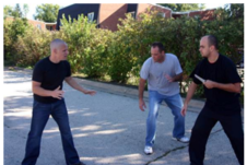 Taking on an armed attacker would ensure that you deal with the more dangerous person first. The last thing you want is to lose sight of the weapon, and have it “surprise” you.   